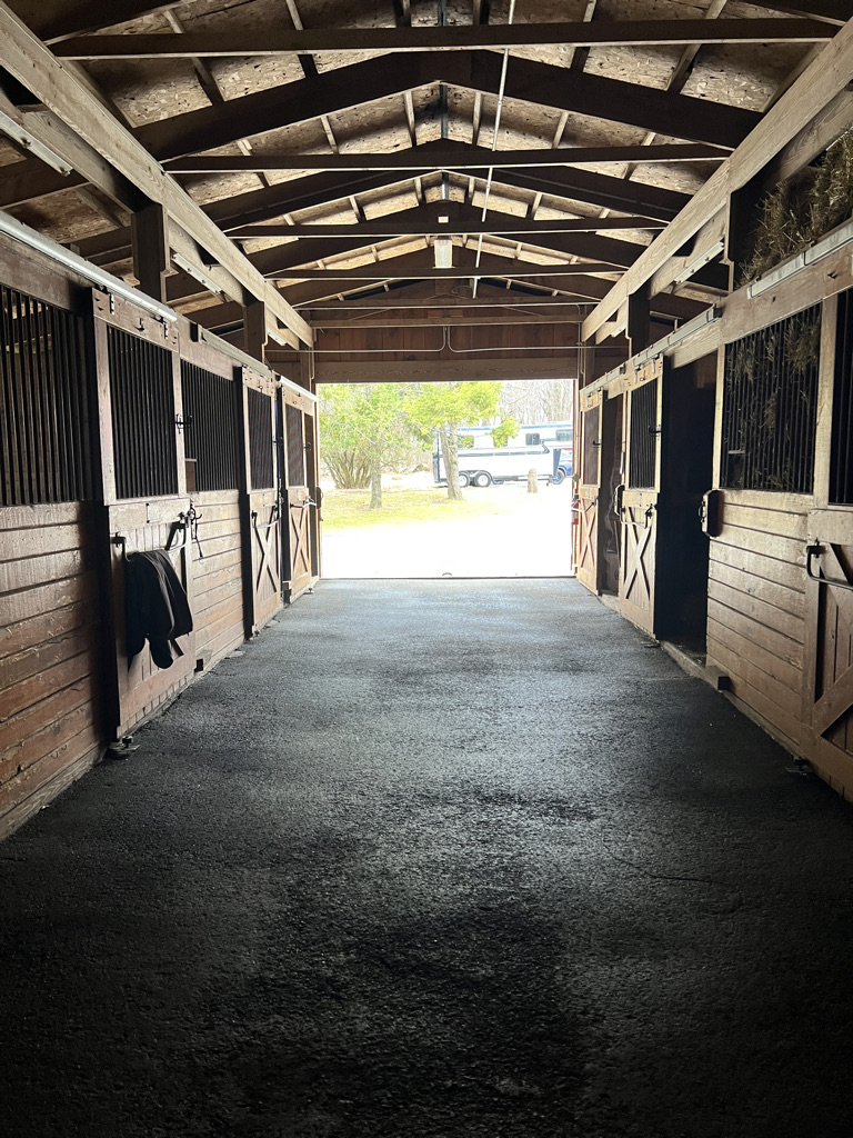 Interior barn aisle with stalls at Furlyn Farm